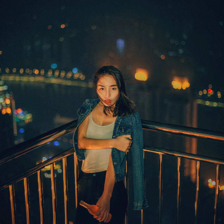 高楼上的咬唇颓废美女牛仔背心隐约现乳沟