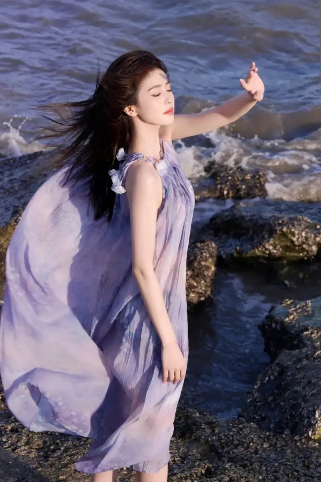 白鹿穿紫色纱裙海边漫步 侧身灿笑明媚如阳光